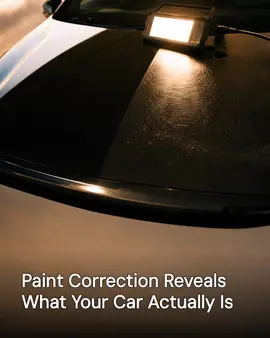 Generated post: work lamp revealing swirl marks on half of a dark car hood, headline about paint correction baked into the image