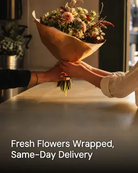 Generated post: two pairs of hands passing a kraft-paper-wrapped bouquet across a counter, headline about fresh flowers wrapped for same-day delivery baked into the image